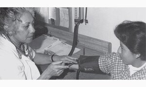 Woman taking blood pressure of child