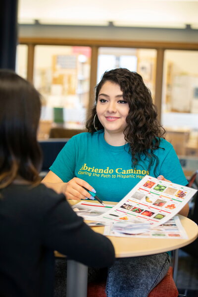woman shares information with student