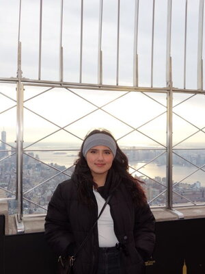 Kailey Reyes poses on top of the empire state building