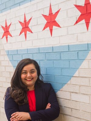 Nancy Cambron Perez Headshot in front of Flag of Chicago Mural 